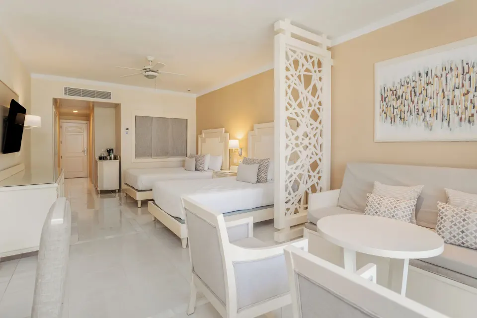 Junior Suite with two beds and sitting area at Bahia Principe Explore Legend.