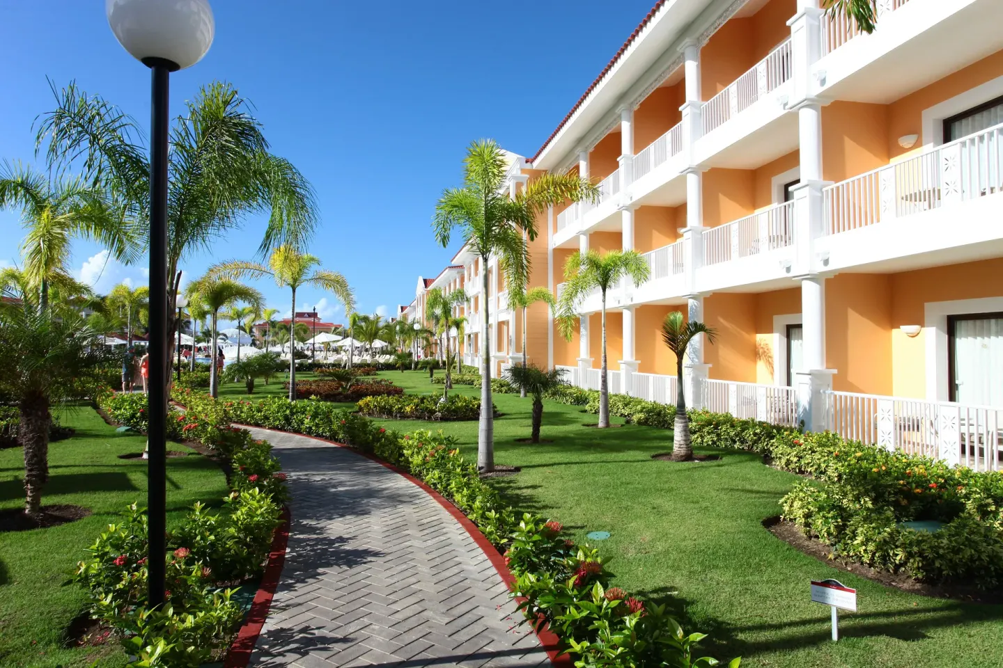 Garden walkway beside guest room buildings at Bahia Principe Grand Aquamarine.