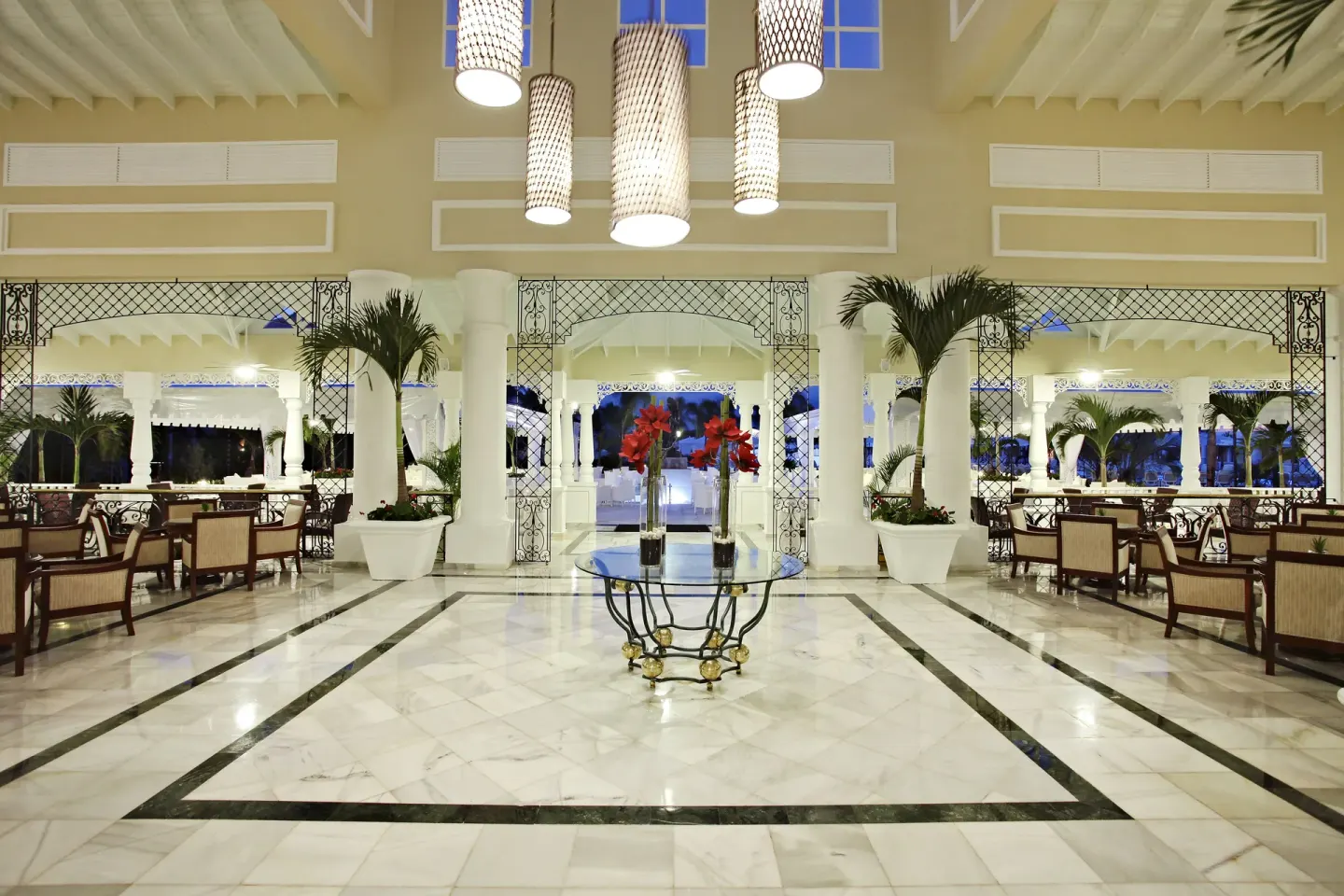 Open lobby with marble floors and lounge seating at Bahia Principe Grand Aquamarine.