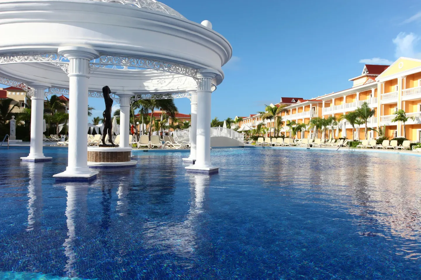 Pool pavilion with columns and a statue at Bahia Principe Grand Aquamarine.