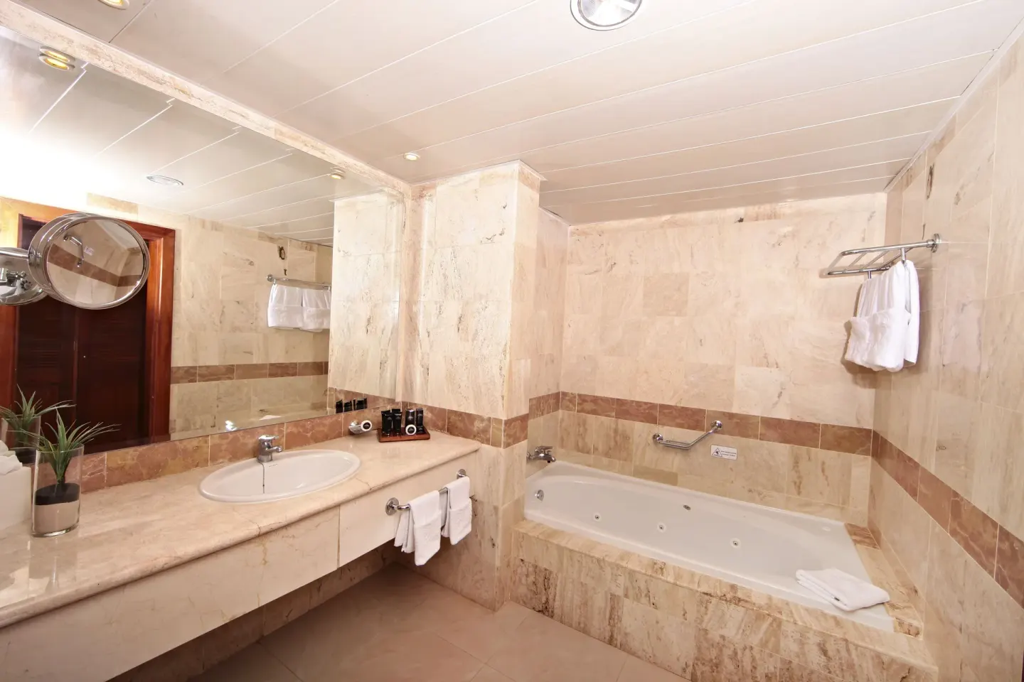 Junior Suite bathroom with tub and vanity at Bahia Principe Grand Aquamarine.