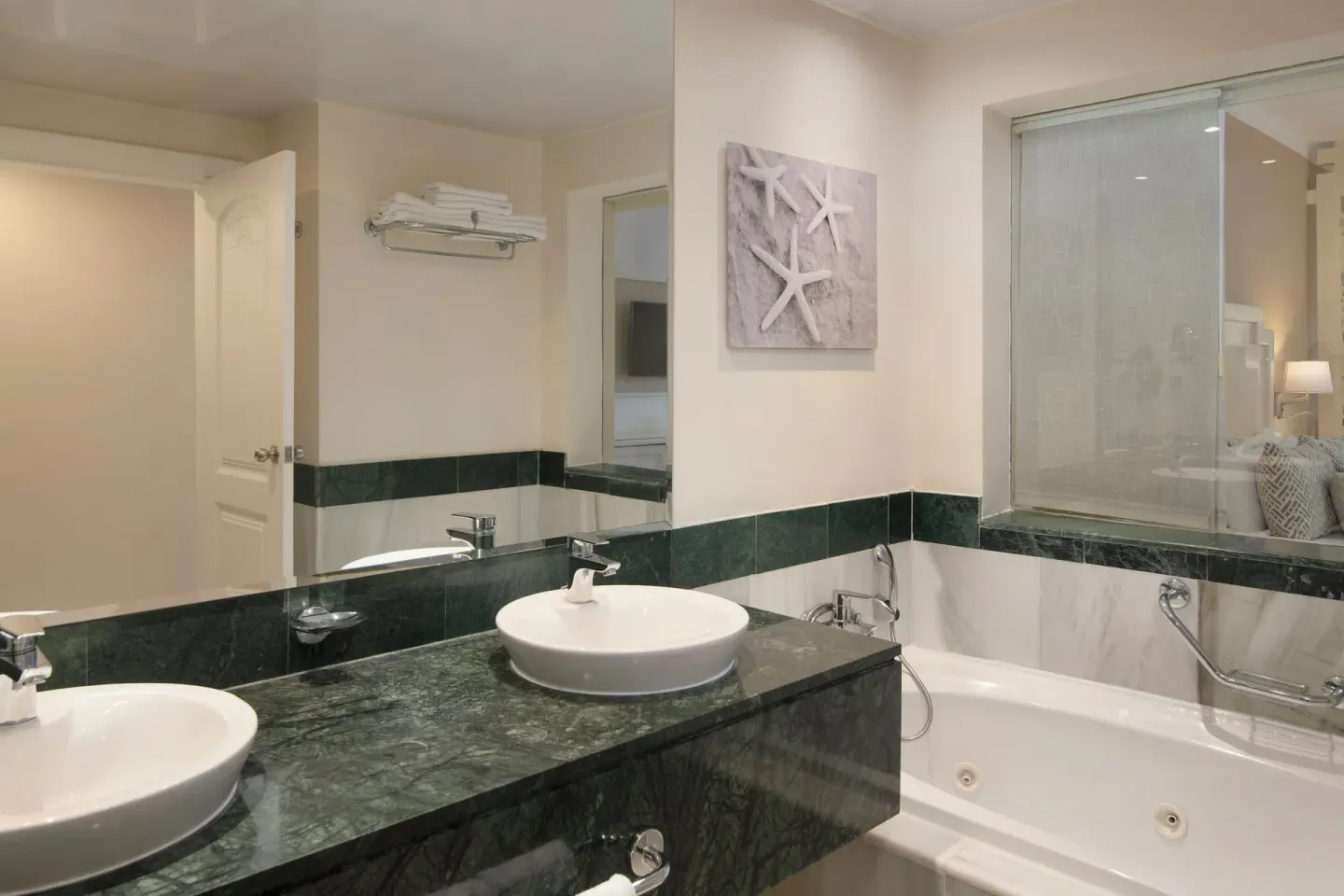 Junior Suite bathroom sinks and bathtub at Bahia Principe Grand Aquamarine.