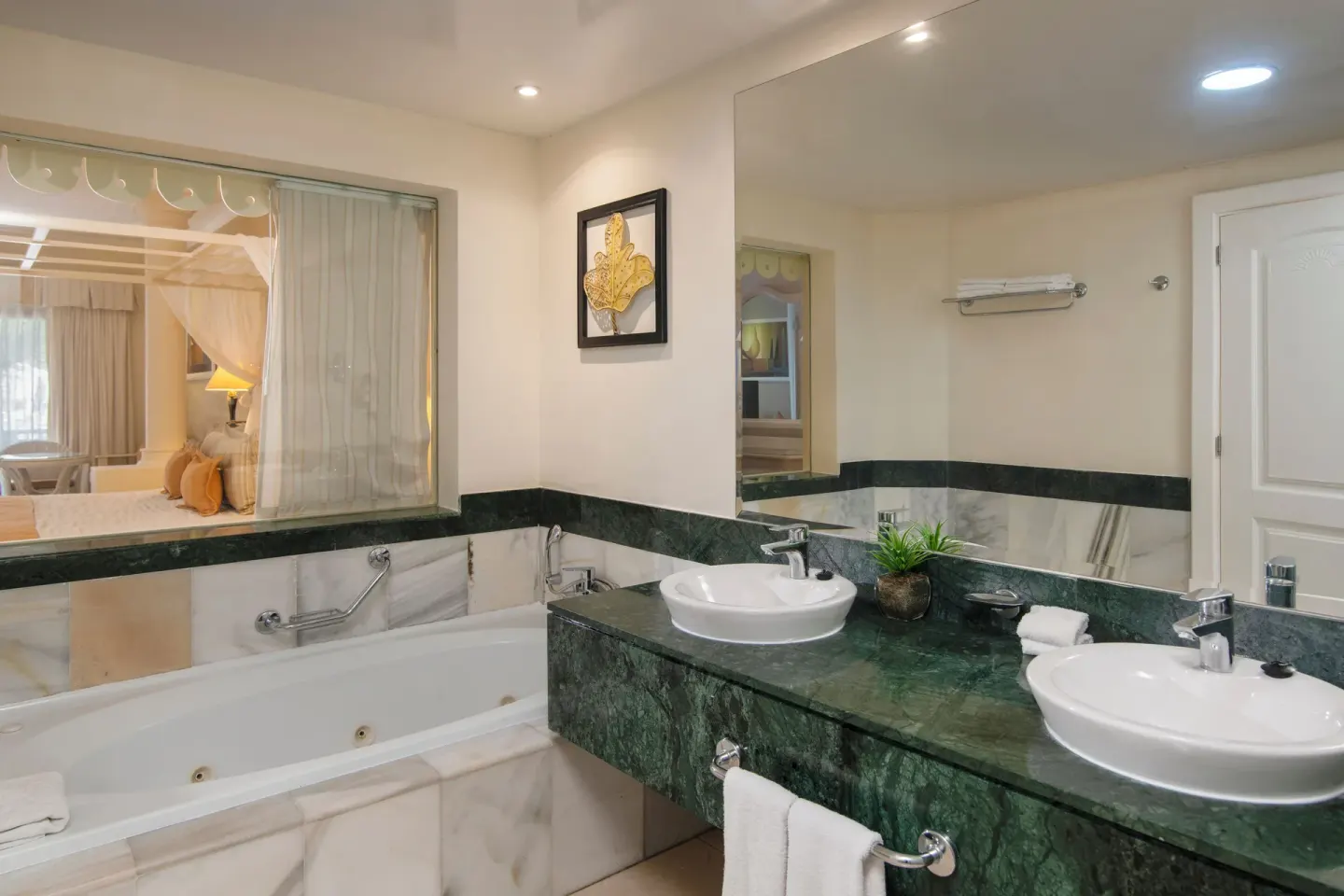 Junior Suite bathroom with double sinks and tub at Bahia Principe Grand Aquamarine.