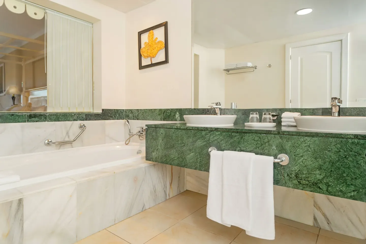 Junior Suite bathroom with tub and double vanity at Bahia Principe Grand Aquamarine.