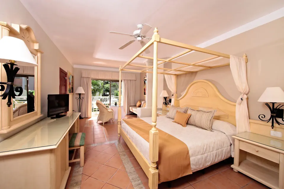 Junior Suite with canopy bed and balcony at Bahia Principe Grand Aquamarine.