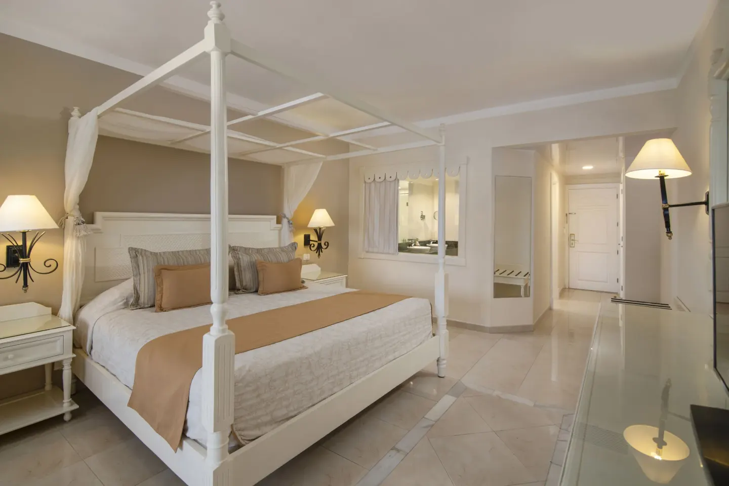 Junior Suite canopy bed and entry area at Bahia Principe Grand Aquamarine.