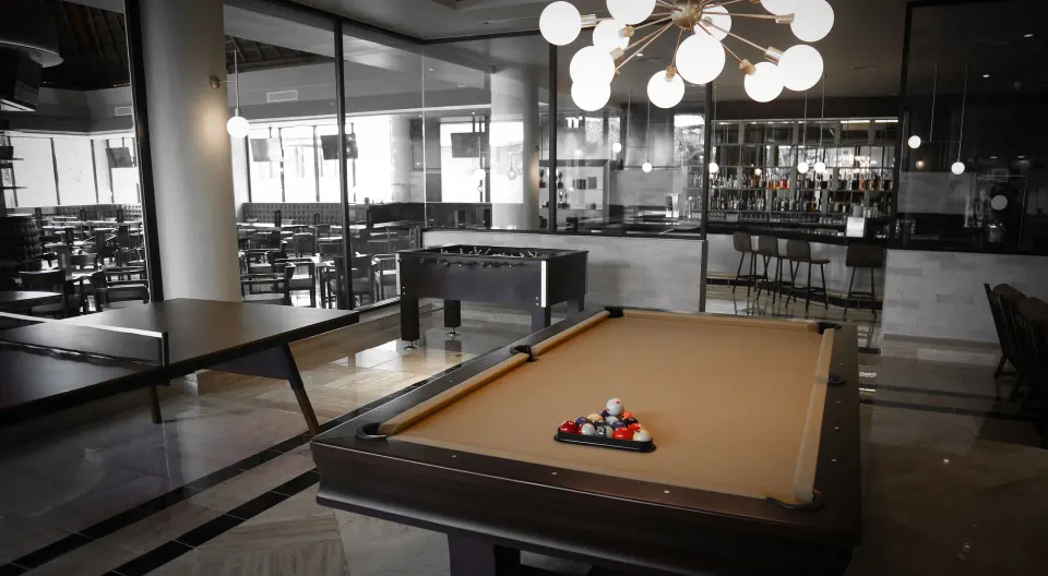 Stylish billiard table in dim lounge area at Bahia Principe Grand Coba