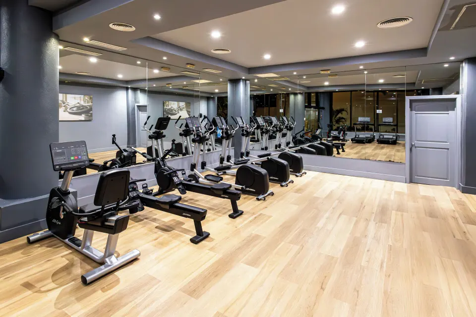 Cardio area with treadmills and recumbent bikes in the resort gym at Bahia Principe Grand Coba.