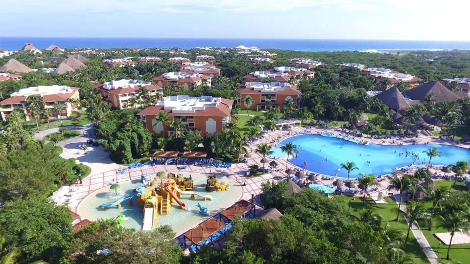 Aerial view of the resort's family pool area with a children’s waterplay zone at Bahia Principe Grand Coba