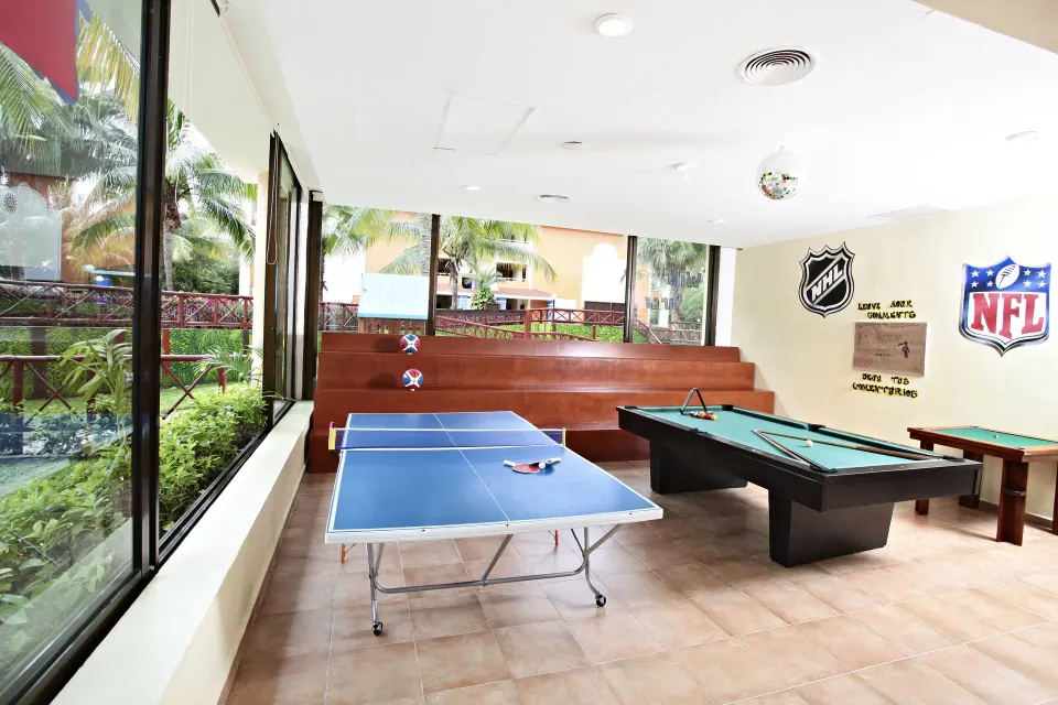 Game room with ping-pong and pool tables at Bahia Principe Grand Coba