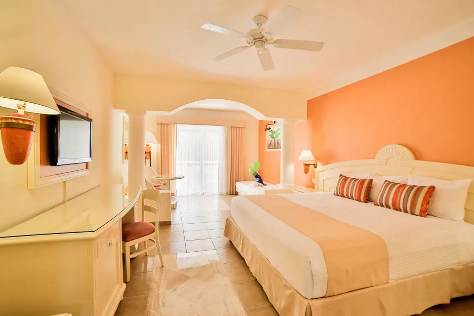 King bed view toward terrace in junior suite at Bahia Principe Grand Coba
