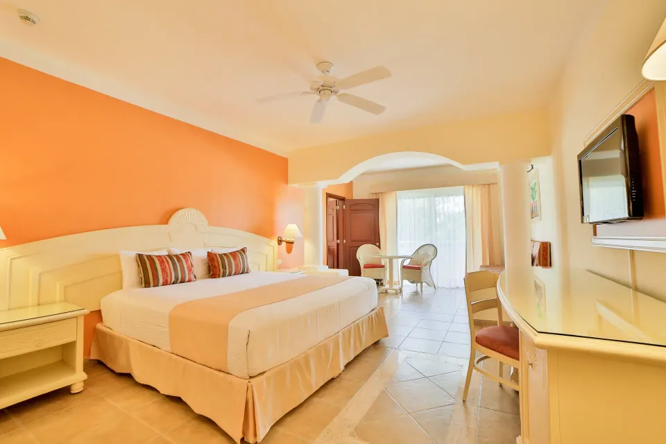 Bright junior suite with king bed and terrace at Bahia Principe Grand Coba