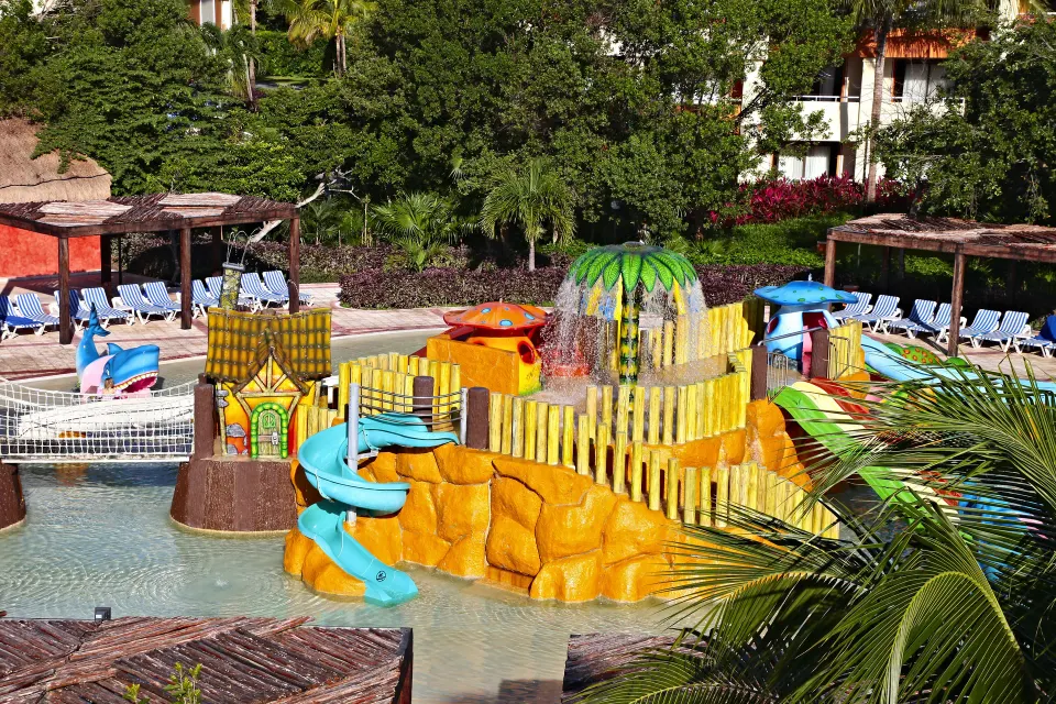 Children's splash play area with slides and water features at Bahia Principe Grand Coba.