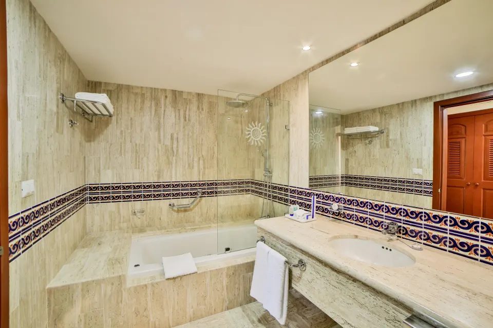 Bathroom with tub and vanity in resort suite at Bahia Principe Grand Coba