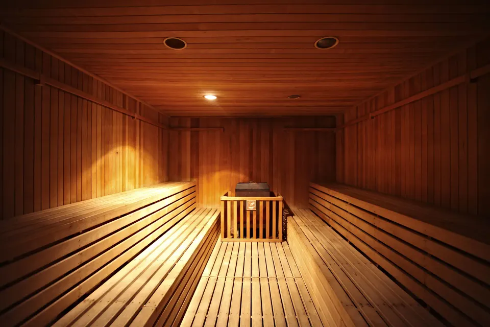 Wood-panel sauna interior with bench seating at Bahia Principe Grand Coba.