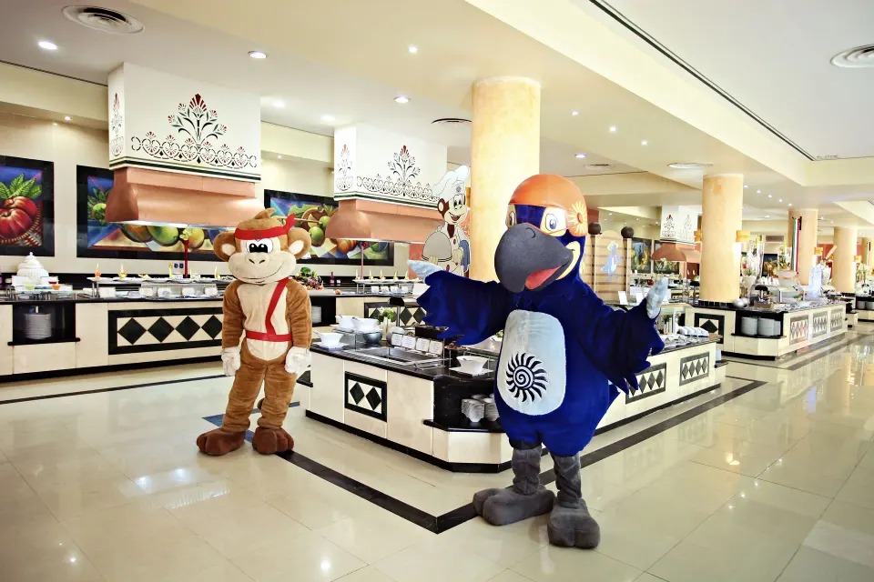 Resort buffet with two costumed characters greeting guests at Bahia Principe Grand Coba