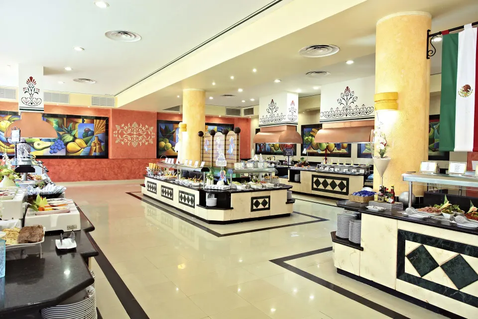 Bright buffet area with salad and hot food stations at Bahia Principe Grand Coba