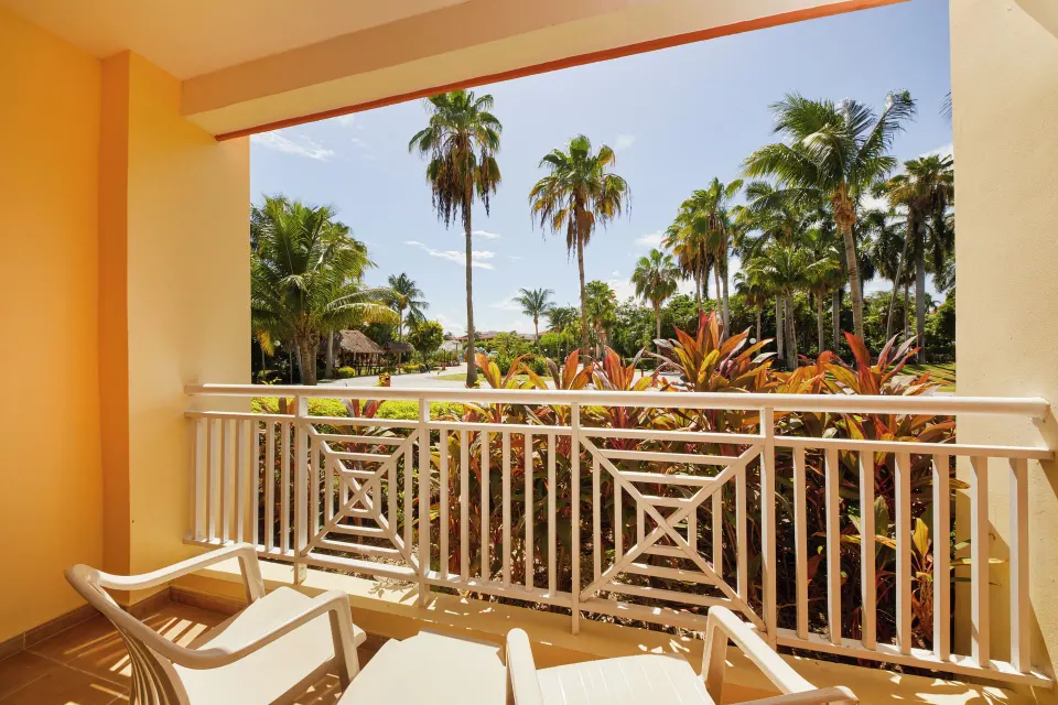 Balcony overlooking landscaped palms and grounds from a junior suite at Bahia Principe Grand Coba