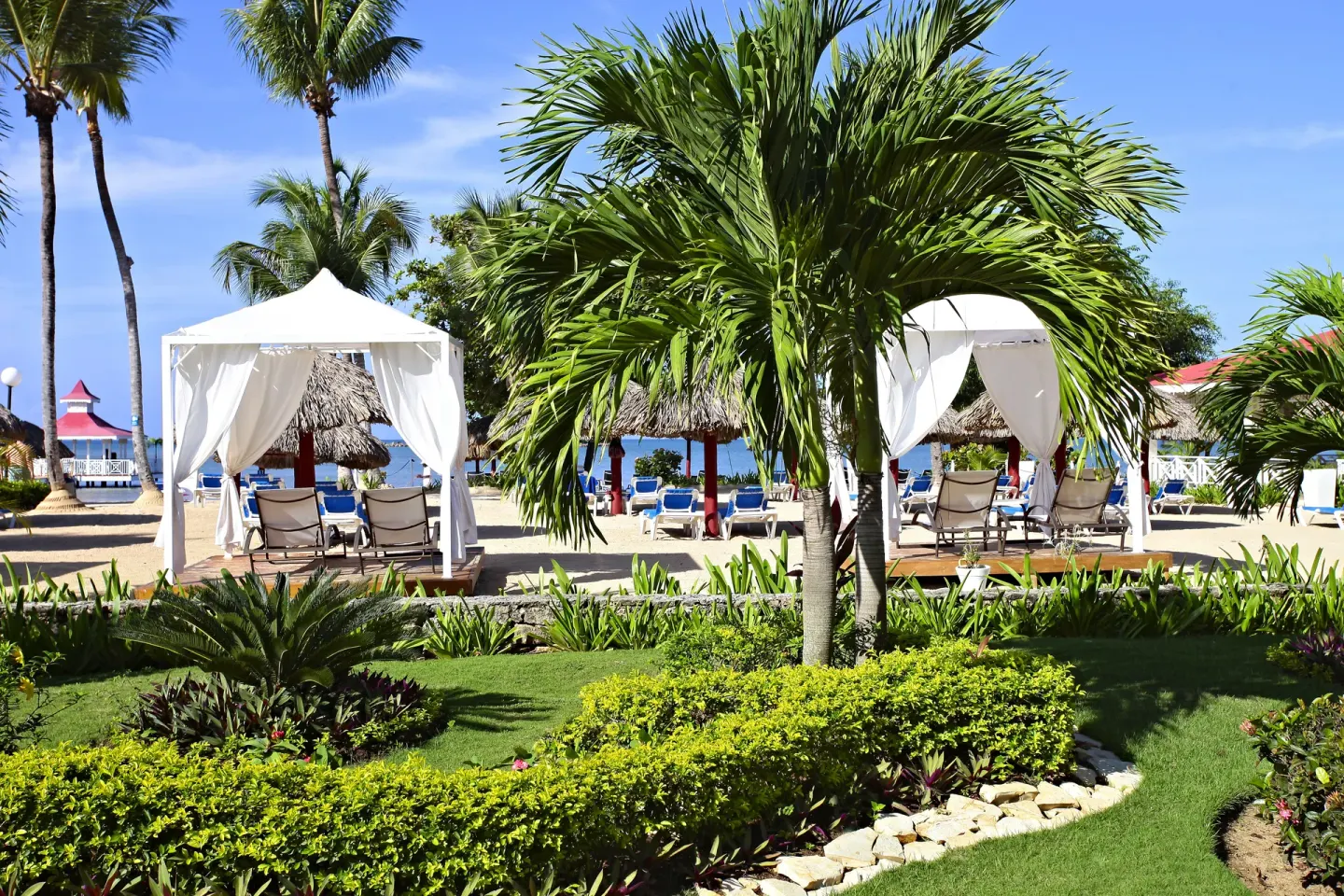 Beach cabanas and tropical gardens at Bahia Principe Grand La Romana.
