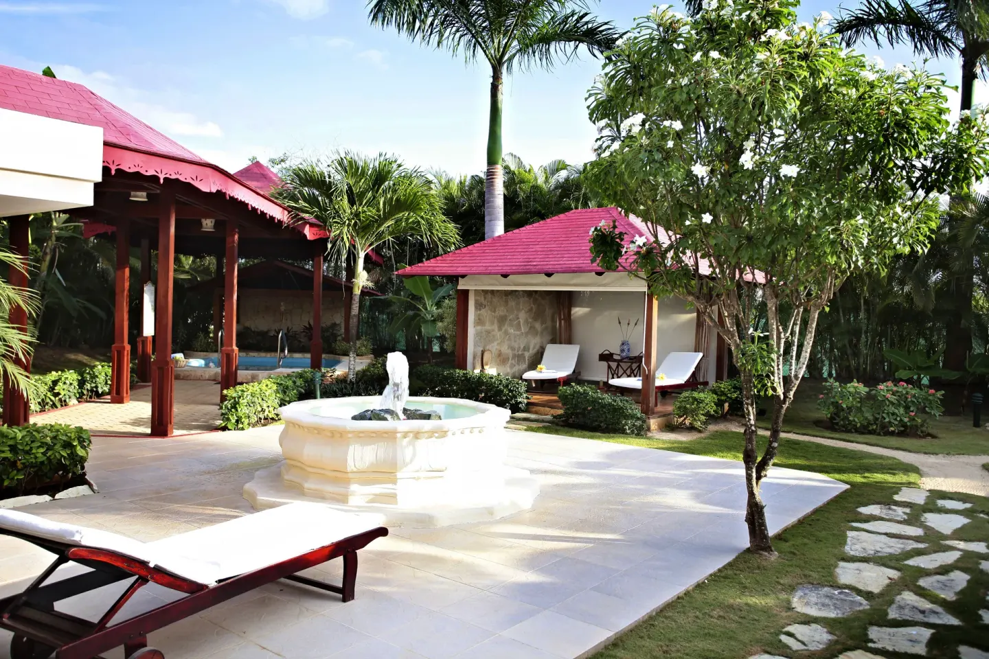 Spa courtyard with fountain, loungers, and tropical gardens at Bahia Principe Grand La Romana.