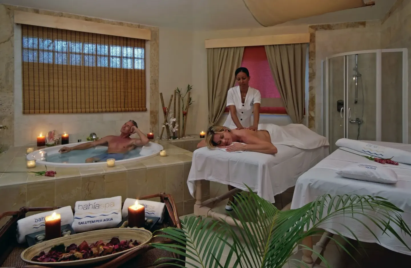 Spa treatment room with massage table and soaking tub at Bahia Principe Grand La Romana.