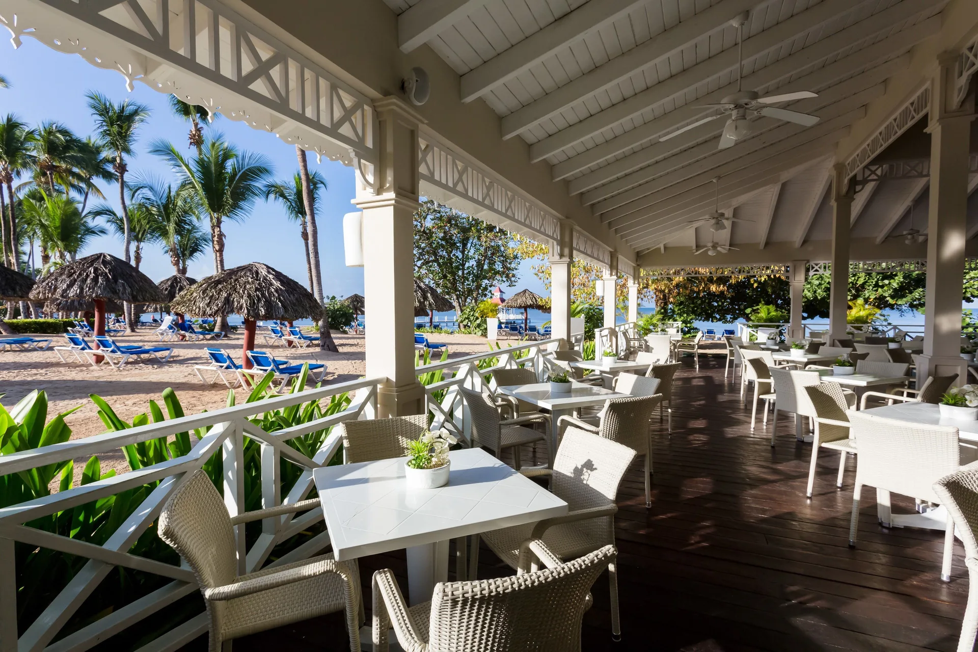 Beachside covered terrace with tables at Bahia Principe Grand La Romana.