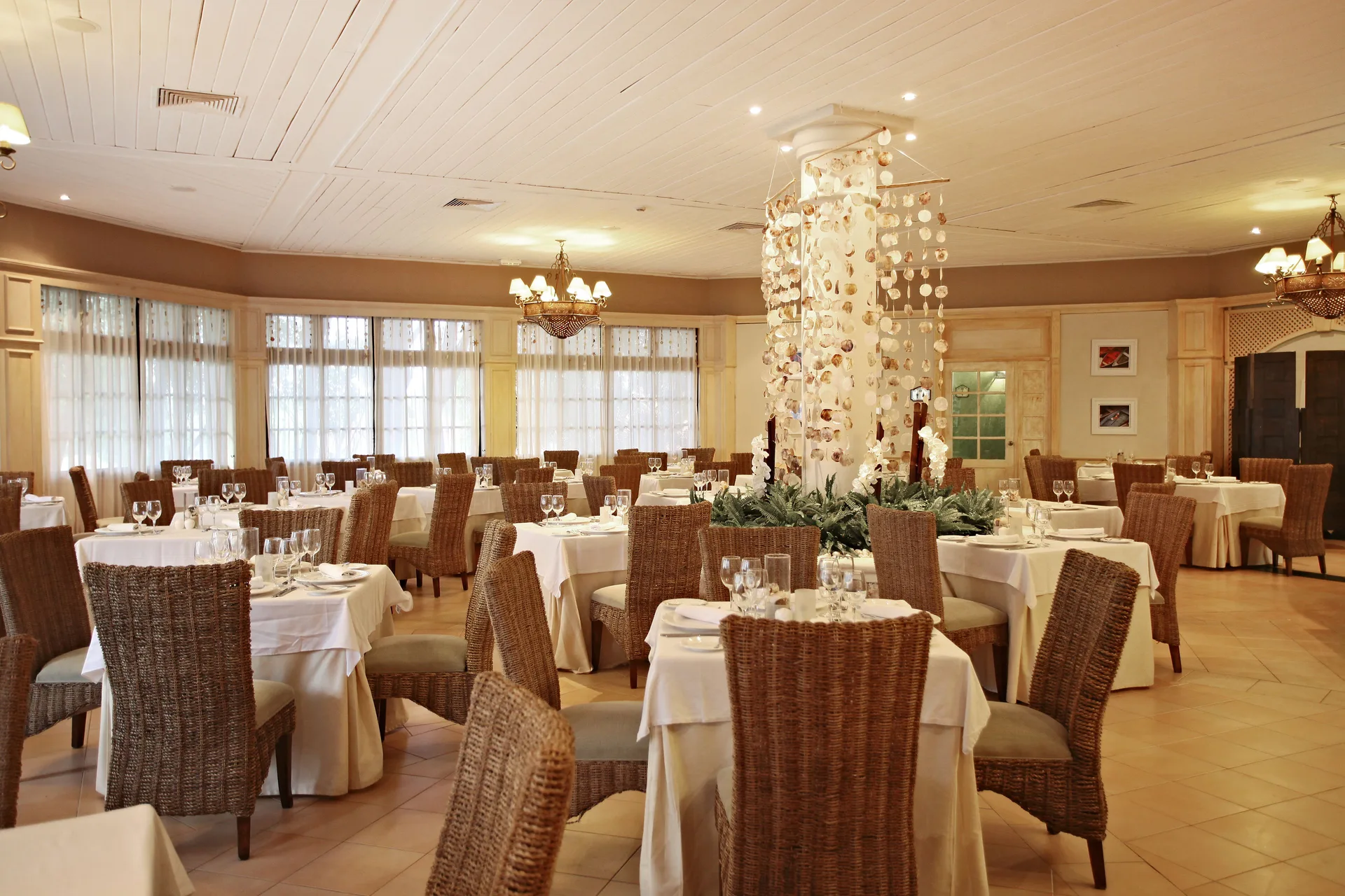 Elegant restaurant dining room with wicker chairs at Bahia Principe Grand La Romana.