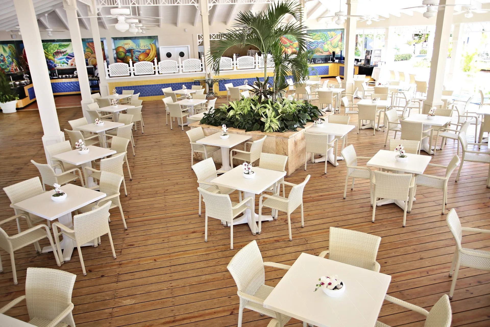 Open-air dining terrace with white tables at Bahia Principe Grand La Romana.