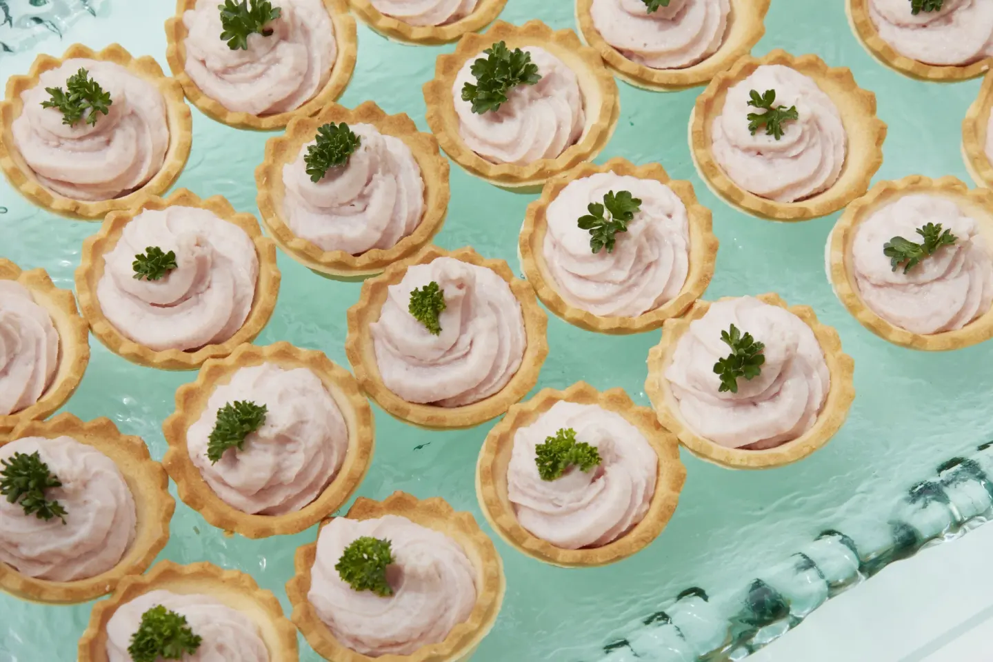 Small tartlets with pink filling and parsley garnish at Bahia Principe Grand La Romana.