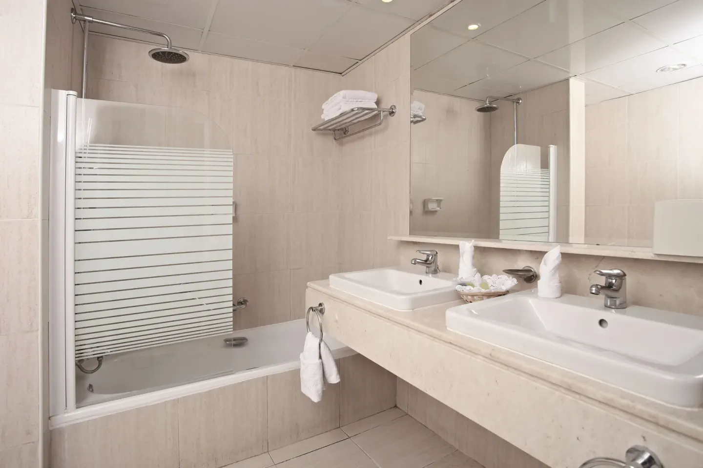 Junior Suite Superior bathroom with double sinks and tub at Bahia Principe Grand La Romana.