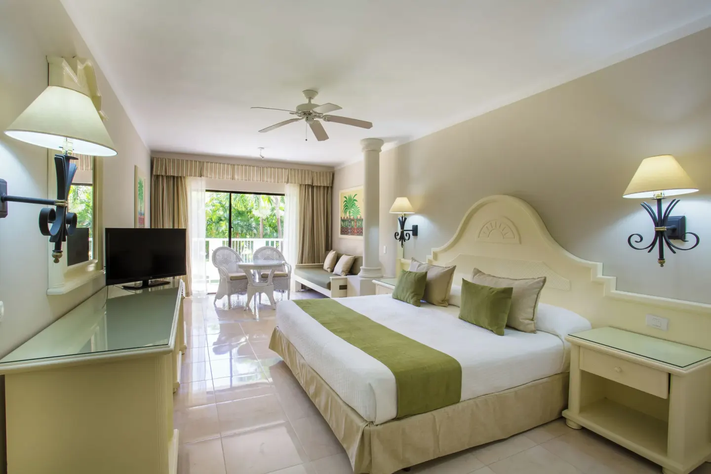 Junior Suite Superior with king bed, sitting area, and balcony at Bahia Principe Grand La Romana.