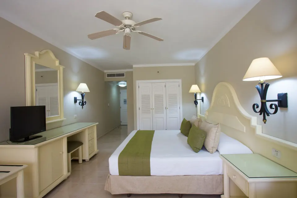 Junior Suite Superior with king bed and vanity at Bahia Principe Grand La Romana.