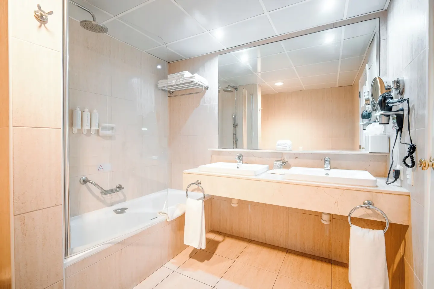 Junior Suite bathroom with bathtub and wide vanity at Bahia Principe Grand La Romana.