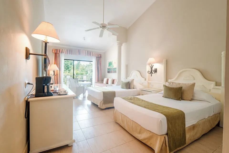 Junior Suite with two beds and balcony seating at Bahia Principe Grand La Romana.