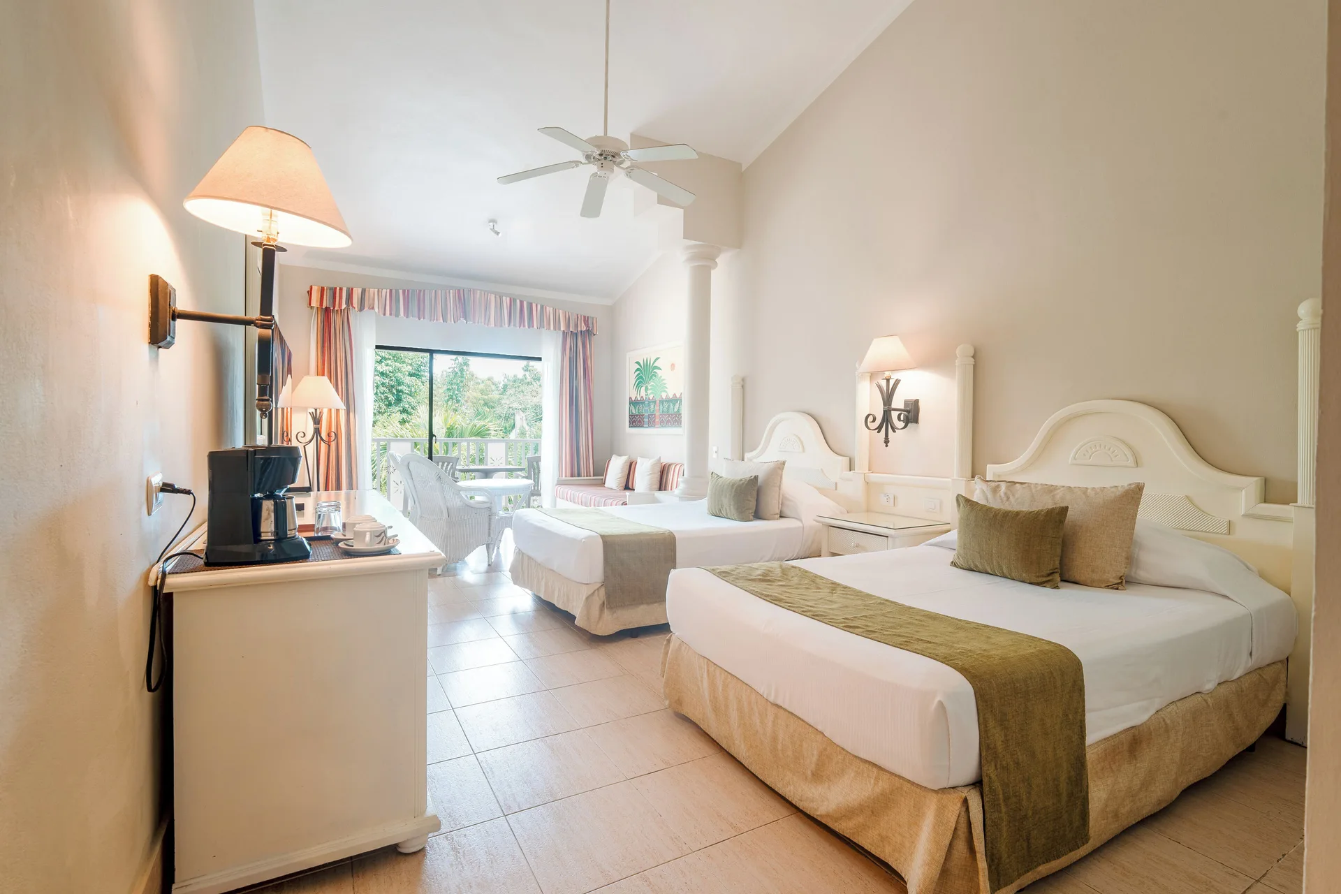 Junior Suite with two beds and balcony seating at Bahia Principe Grand La Romana.