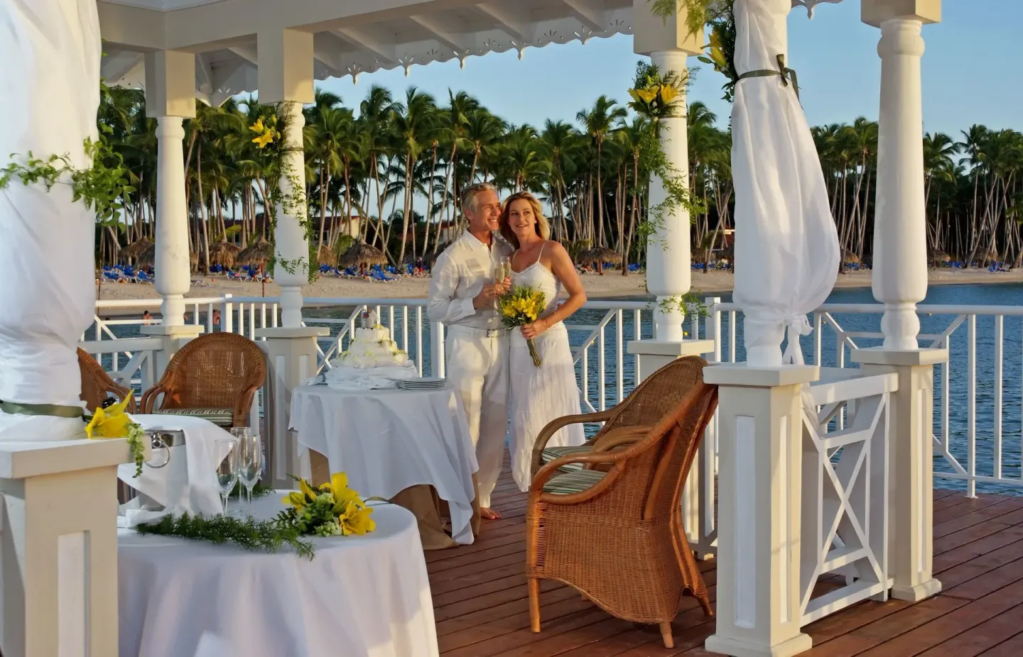 Wedding couple inside the seaside gazebo at Bahia Principe Grand La Romana with beach in view.