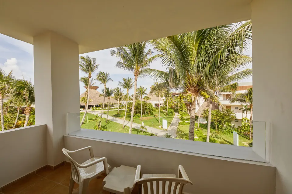 Balcony view over landscaped grounds and palm trees at Bahia Principe Grand Tulum