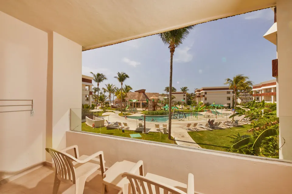 Balcony overlooking resort pool and play area at Bahia Principe Grand Tulum