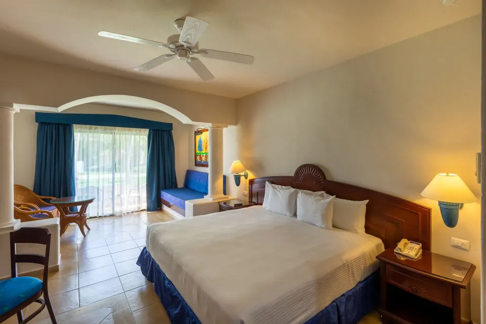 Guest room with king bed and patio at Bahia Principe Grand Tulum