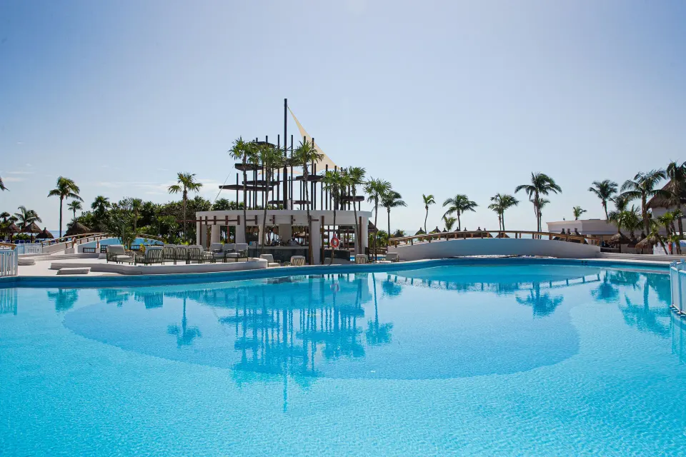 Large resort pool and central palapa structure at Bahia Principe Grand Tulum