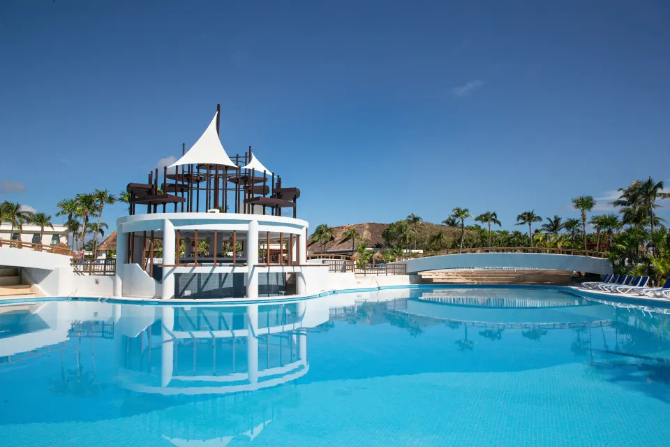 Resort pool with circular swim-up bar structure at Bahia Principe Grand Tulum