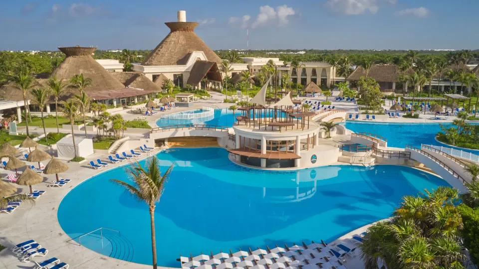 Aerial view of the large resort pool and surrounding sun loungers at Bahia Principe Grand Tulum