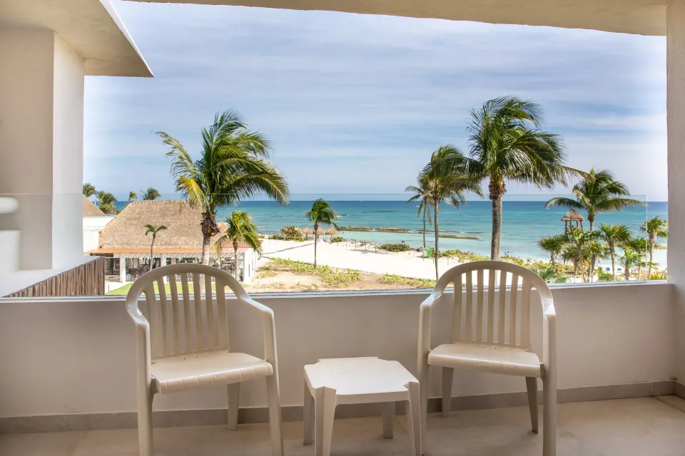 Balcony with chairs and clear ocean view at Bahia Principe Grand Tulum