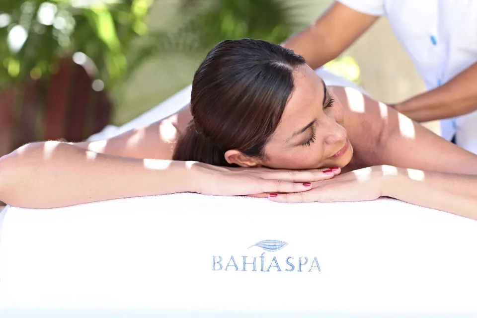 Guest receiving a relaxing outdoor back massage at Bahia Principe Grand Tulum spa
