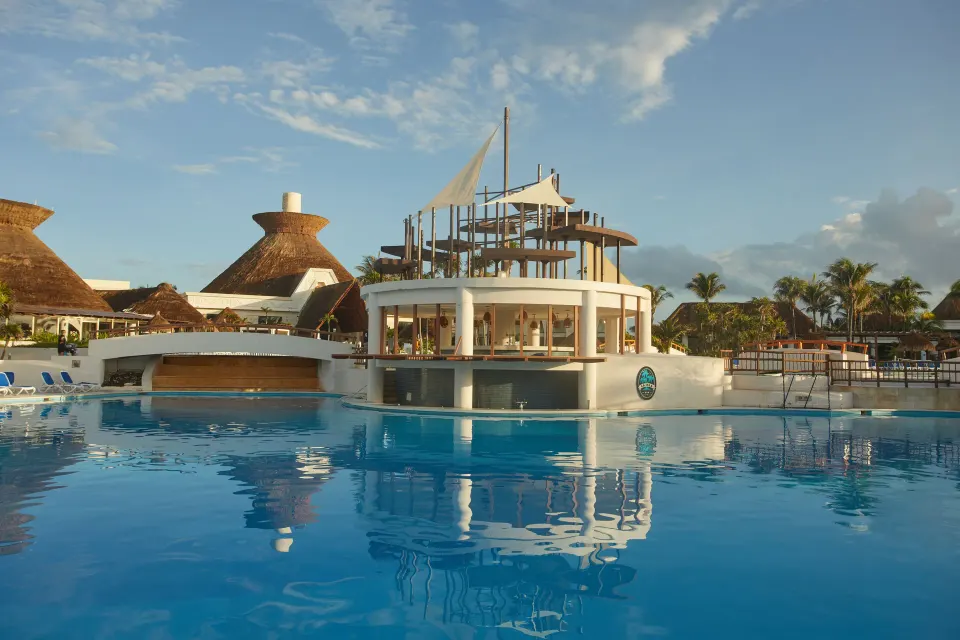 Round swim-up bar structure in the central pool at Bahia Principe Grand Tulum