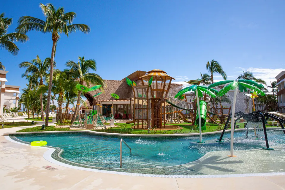 Water playground and surrounding pool with a wooden play tower at Bahia Principe Grand Tulum