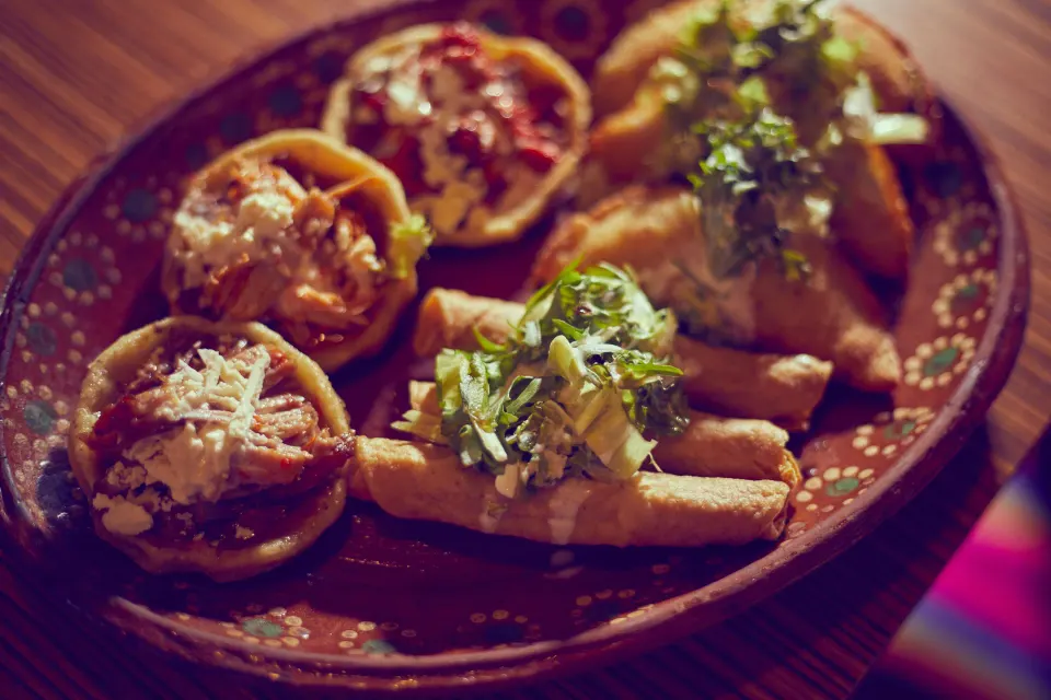 Assorted Mexican appetizers on a decorative plate at Bahia Principe Grand Tulum