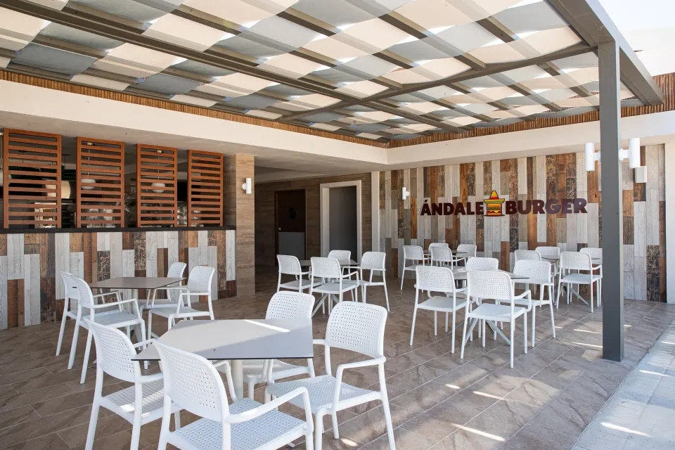 Outdoor seating and entrance to Burger Andale at Bahia Principe Grand Tulum