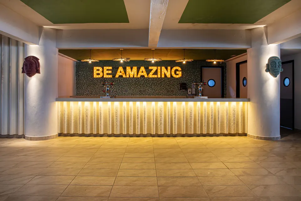 Illuminated bar with 'BE AMAZING' sign at Bahia Principe Grand Tulum