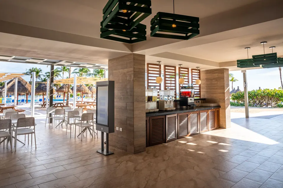 Open-air poolside snack counter and seating at Bahia Principe Grand Tulum